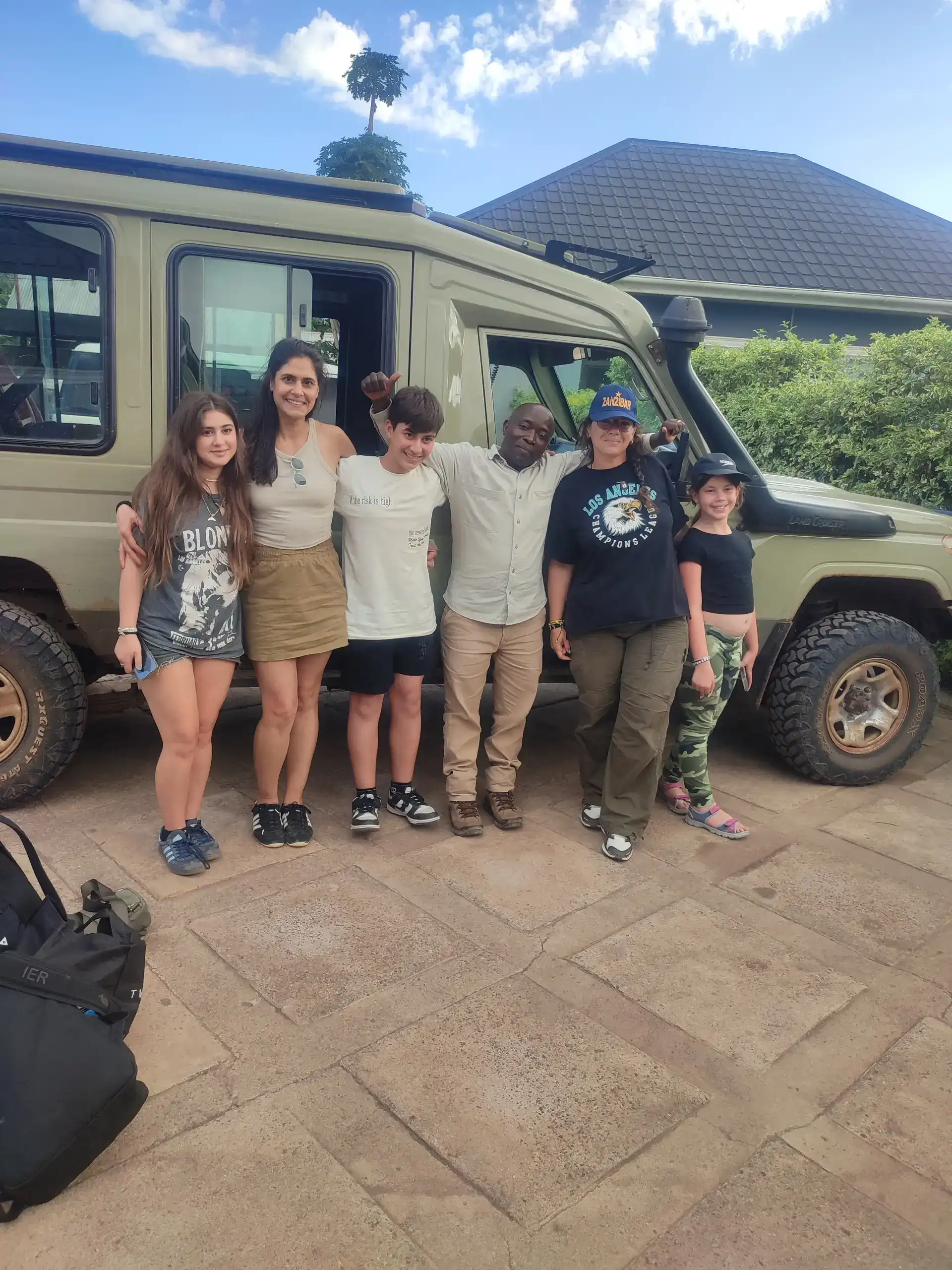 Tourists interacting joyfully with the Tanzanian Maasai community on a cultural safari